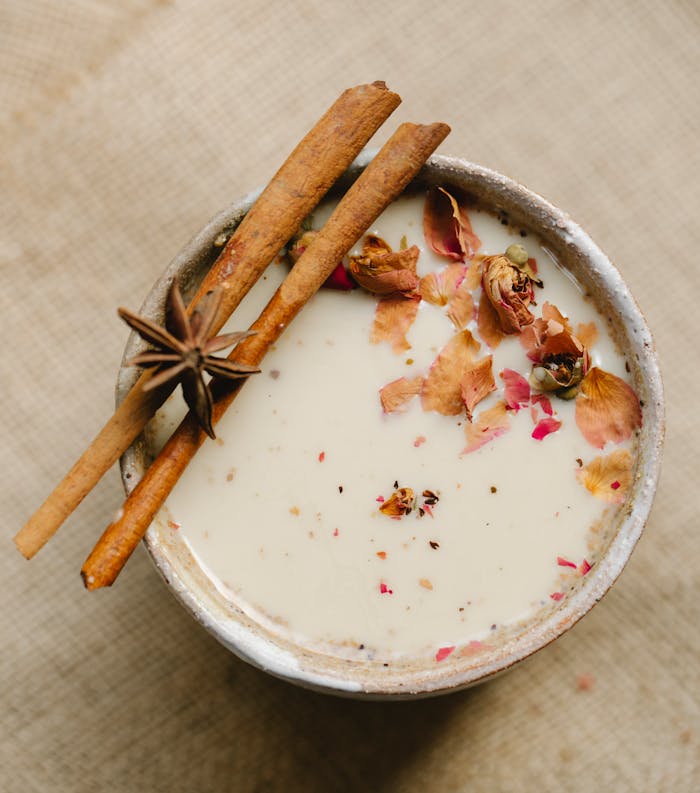 pexels-photo-5946612 Top view of traditional Indian tea with milk cinnamon sticks and star anise placed on blurred background in light kitchen